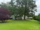 Beautifully landscaped front yard with mature trees and a well-maintained home at 6300 Fox Hunt Rd, Indian Trail, NC 28079
