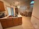 Classic kitchen features oak cabinetry, a sink, and a view into a dining area at 6300 Fox Hunt Rd, Indian Trail, NC 28079