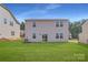 Well-maintained backyard featuring a lush lawn and the rear facade of the home with double-hung windows at 6301 Fairfax Ct, Maiden, NC 28650