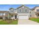 Charming two-story home features a two-car garage, blue door, and manicured front lawn at 6301 Fairfax Ct, Maiden, NC 28650