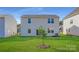 Large backyard with a lush green lawn, young tree, and rear exterior view of the house at 6337 Fairfax Ct, Maiden, NC 28650