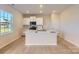 Modern kitchen featuring white cabinets, a central island with sink, and stainless steel appliances at 6337 Fairfax Ct, Maiden, NC 28650