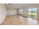 Bright living room with gleaming hardwood floors, large windows, and a sliding glass door at 6337 Fairfax Ct, Maiden, NC 28650