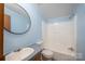 A well-lit bathroom features a bath tub, vanity, and light blue wall for a clean and airy feel at 6903 Knottywood Ln # 21, Vale, NC 28168