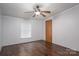 An ample bedroom with dark wood floors and a modern ceiling fan provides a cool, quiet atmosphere at 6903 Knottywood Ln # 21, Vale, NC 28168