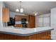 Kitchen featuring wood cabinets, modern appliances, ample countertop space, and stylish lighting at 6903 Knottywood Ln # 21, Vale, NC 28168