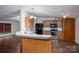 View of the kitchen with wood cabinets, black appliances, stainless steel oven, and a dining bar at 6903 Knottywood Ln # 21, Vale, NC 28168