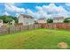 Large backyard with wooden fence, swing set, and ample space for outdoor activities at 693 Carybrook Ct, York, SC 29745