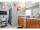 Bathroom with double sink vanity, granite countertop, dark wood cabinets, and a shower at 693 Carybrook Ct, York, SC 29745