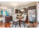 Cozy dining area features hardwood floors, a stylish table set, and modern lighting, adjacent to the kitchen at 693 Carybrook Ct, York, SC 29745