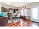 Cozy dining area features hardwood floors, a stylish table set, and modern lighting, adjacent to the kitchen at 693 Carybrook Ct, York, SC 29745