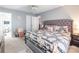 Comfortable main bedroom with a ceiling fan, upholstered headboard, and en-suite bathroom at 693 Carybrook Ct, York, SC 29745