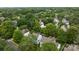 Overhead shot showcases the neighborhood's mature trees and the charming rooftops of the homes below at 720 Camaross Dr, Charlotte, NC 28270