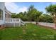 A backyard features a white fence, green grass, and a slide at 720 Camaross Dr, Charlotte, NC 28270