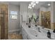 Elegant bathroom with double sinks, neutral tile, and a glass-enclosed shower at 720 Camaross Dr, Charlotte, NC 28270