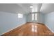 Spacious bedroom featuring hardwood floors, plenty of natural light, and a sloped ceiling at 720 Camaross Dr, Charlotte, NC 28270