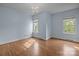 Spacious bedroom features hardwood floors, two windows providing ample natural light, and modern chandelier at 720 Camaross Dr, Charlotte, NC 28270