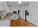 Bright kitchen with white cabinetry, granite countertops, and stainless steel appliances at 720 Camaross Dr, Charlotte, NC 28270