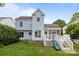 Light blue two-story home with a screened-in porch, slide, and wooden staircase from the backyard at 720 Camaross Dr, Charlotte, NC 28270