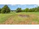 Extensive backyard featuring lush greenery, scattered trees, and a shed at 7990 W Nc 152 Hwy, Mooresville, NC 28115