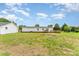 Large backyard with mature trees, wooden deck, and a detached garage at 7990 W Nc 152 Hwy, Mooresville, NC 28115