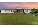 Charming ranch-style home with a welcoming front porch, lush lawn, and classic white siding at 7990 W Nc 152 Hwy, Mooresville, NC 28115
