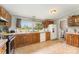 Kitchen area featuring wooden cabinets, sink with window, and white appliances at 7990 W Nc 152 Hwy, Mooresville, NC 28115
