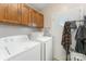 Functional laundry room with washer, dryer, and storage cabinets at 7990 W Nc 152 Hwy, Mooresville, NC 28115
