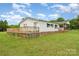 Lovely home featuring a spacious back deck for entertaining, complemented by a well-maintained lawn at 7990 W Nc 152 Hwy, Mooresville, NC 28115