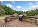 Spacious wooden back deck with grill, perfect for outdoor cooking and overlooking the lush backyard at 800 Isle Of Palms Ct, Fort Mill, SC 29708