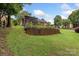 Lush green backyard featuring a raised garden, and view of the back of the home with back deck at 800 Isle Of Palms Ct, Fort Mill, SC 29708