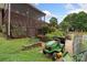 Landscaped backyard with garden area and back deck with stairs from an upper level, and lawn equipment at 800 Isle Of Palms Ct, Fort Mill, SC 29708
