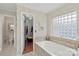 Bathroom featuring a soaking tub with views of a closet at 800 Isle Of Palms Ct, Fort Mill, SC 29708