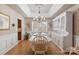 Elegant dining room featuring a tray ceiling, chandelier, and ample natural light at 800 Isle Of Palms Ct, Fort Mill, SC 29708