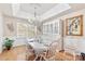Bright dining room with stylish chandelier, white table set, and hardwood floors at 800 Isle Of Palms Ct, Fort Mill, SC 29708