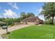Charming front exterior of home with a well-manicured lawn, long driveway, and a three car garage at 800 Isle Of Palms Ct, Fort Mill, SC 29708