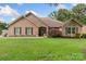 Attractive brick home featuring a lush green lawn, mature trees and welcoming curb appeal at 800 Isle Of Palms Ct, Fort Mill, SC 29708