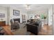 Comfortable living area featuring a fireplace, hardwood flooring, and views into dining area at 800 Isle Of Palms Ct, Fort Mill, SC 29708