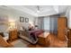 Luxurious main bedroom featuring hardwood floors, tray ceiling, and elegant furnishings at 800 Isle Of Palms Ct, Fort Mill, SC 29708