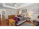 Spacious main bedroom featuring hardwood floors, tray ceiling, and elegant furnishings at 800 Isle Of Palms Ct, Fort Mill, SC 29708