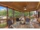 Cozy screened porch with seating, ceiling fan, and ambient lighting, creating an inviting outdoor space at 800 Isle Of Palms Ct, Fort Mill, SC 29708