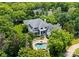 Expansive home with lush landscaping and a private pool and spa in a wooded setting at 8813 Covey Rise Ct, Charlotte, NC 28226