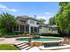 Expansive backyard featuring a luxurious pool with stone accents and lush landscaping for privacy at 8813 Covey Rise Ct, Charlotte, NC 28226