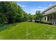 Expansive lush green lawn in the backyard, surrounded by mature trees, providing ample space for outdoor activities at 8813 Covey Rise Ct, Charlotte, NC 28226