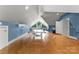 Spacious bonus room featuring hardwood floors, a triangular window, and a Prince table tennis setup at 8813 Covey Rise Ct, Charlotte, NC 28226