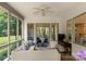 Relaxing screened-in porch with comfortable seating, tv, and serene views of the lush green backyard at 8813 Covey Rise Ct, Charlotte, NC 28226