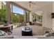 Inviting covered patio with ample seating, ceiling fans, and serene views of the lush backyard and pool at 8813 Covey Rise Ct, Charlotte, NC 28226