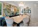 Dining room featuring custom wallpaper, unique light fixture, and seating for eight at 8813 Covey Rise Ct, Charlotte, NC 28226