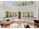 Bright and open foyer with hardwood floors, curved staircase, and an abundance of natural light from large windows at 8813 Covey Rise Ct, Charlotte, NC 28226