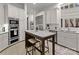 Elegant kitchen featuring white cabinets, marble counters, and a stainless steel refrigerator at 8813 Covey Rise Ct, Charlotte, NC 28226